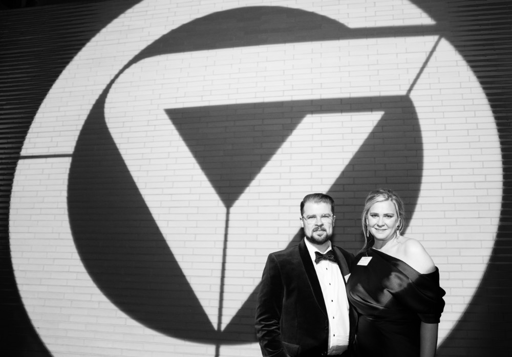 Guests posing in front of large GVSU logo at Enrichment